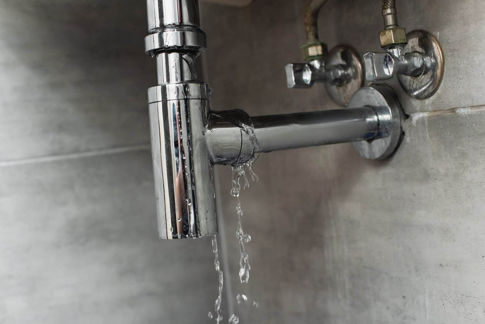 Leaking pipe causing water damage, plumbing repair service.