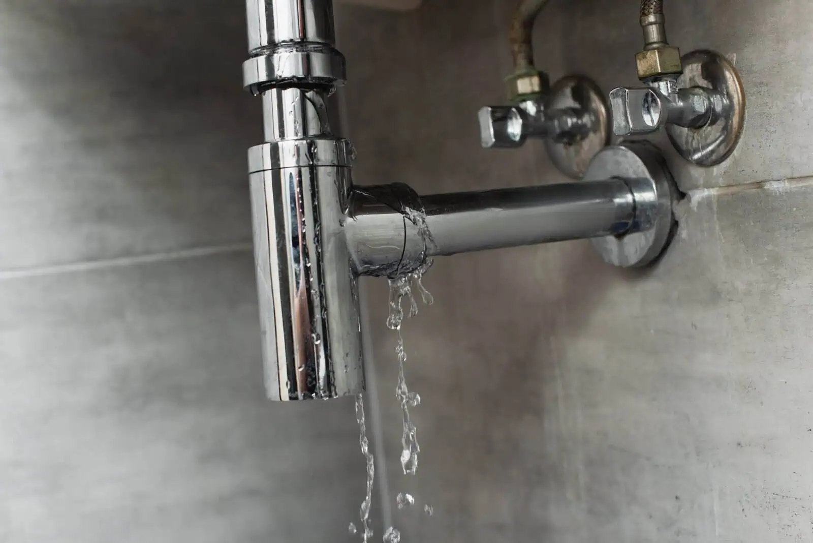 Leaking pipe causing water damage, plumbing repair service.